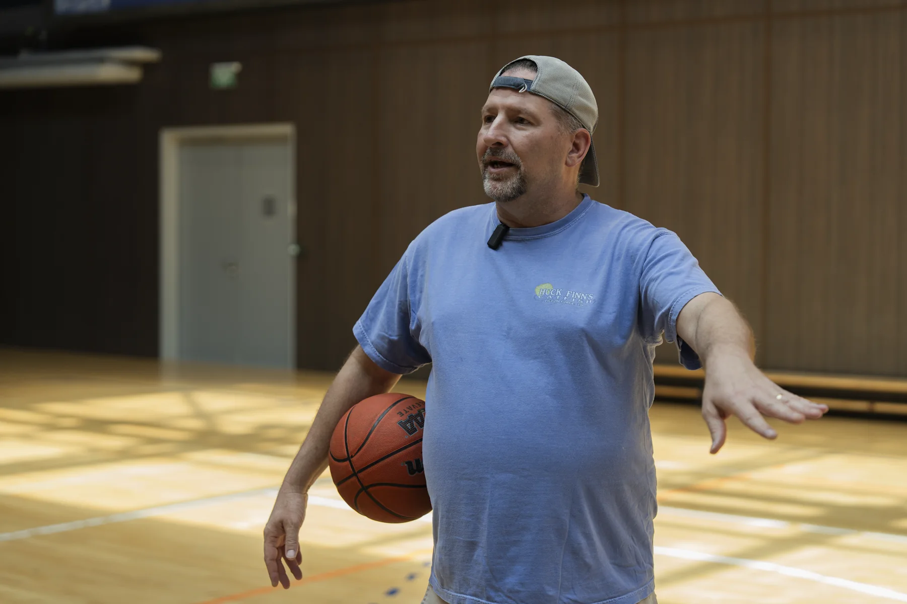 Brad Barton on a basketball court, holding a ball